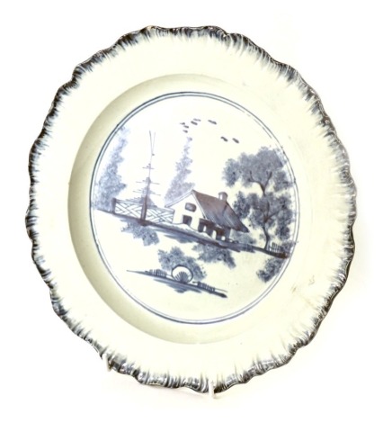 A late 18th/early 19thC pearl ware blue and white cabinet plate, with a fluted border, and a central scene of thatched cottage, 25cm diameter.