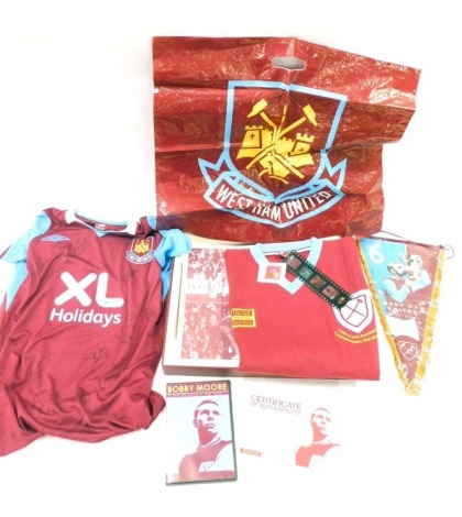 A Bobby Moore 50th anniversary box set, limited edition number 390 of 544, to include shirts, DVD etc.