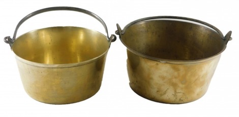 Two similar late 19th/early 20thC brass preserve pans, each with a loop handle.