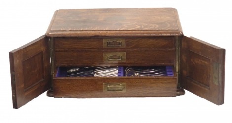 A part canteen of silver plated rat-tail cutlery, mainly for twelve place settings, to include some associated pieces, in oak case with vacant cartouche.