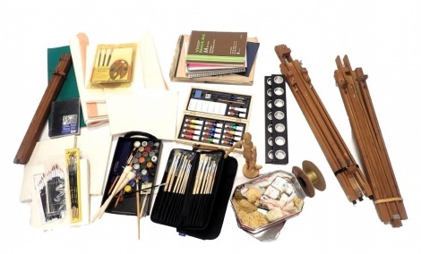 A quantity of artist's materials, easels, paintbrushes, paper, etc.