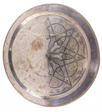 A large silver plated circular tray, engraved with a star and various other motifs, within a gadrooned border, 55.5cm diameter.