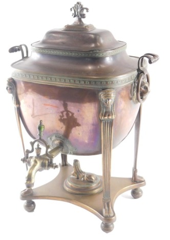 A 19thC Egyptian Revival copper and brass two handled tea urn or samovar, with fleur de lys finial, the base with caryatids, on bun feet, 33cm high.