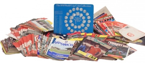 A large quantity of Nottingham Forest football programmes, mainly 1980s, and various Esso and other collectable football medallions.