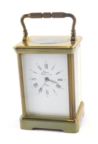 A Rapport French brass carriage time piece, with hinged handle, 17cm high.