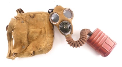 A WWII respirator or gas mask, with labels stating worn by W L Wood of 142 Heanor Road, Smalley for use on police reserve duty, in canvas bag.