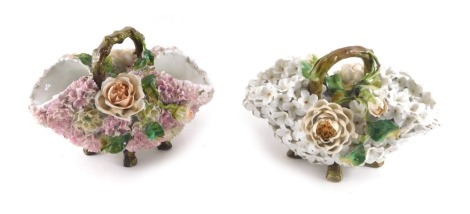 Two 19thC porcelain baskets, each elaborately flower encrusted with flowers to include roses, etc., with stylised twig handle.