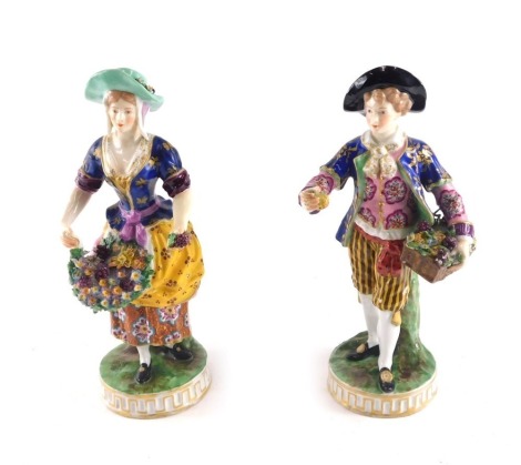 A pair of porcelain figures, each modelled in the form of a gentleman and lady holding flowers, pseudo Derby mark to reverse, possibly Samson, 23cm high.