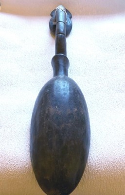 An African tribal Baule Goli Prestige spoon, carved with a devil style figure to the finial, shaped handle, circa 1950, 65cm long. - 2