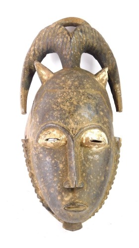 An African tribal Baule meditation peale mask, Cote D'Ivoire circa 1950, 30cm high.