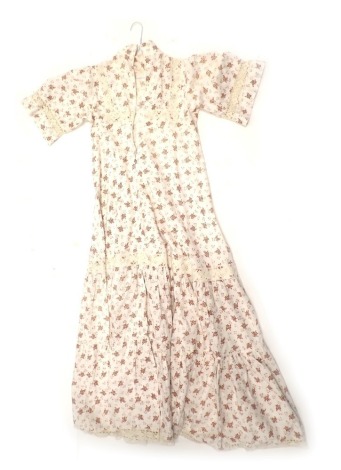 An early 1970s size 10 Laura Ashley vintage dress, decorated with brown flowers on a white ground with ivory lace embellishment.