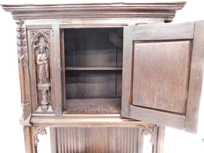 A 19thC oak carved Gothic cabinet, the rectangular top above a carved and frieze door, with two figure caryatids, and a lower shelf, on stiles, 142cm high, 85cm wide, 44cm deep. - 3