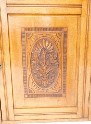 A late Victorian oak sideboard, the top with a moulded edge, above two frieze drawers, and two carved doors flanked by fluted cylindrical plasters, lacking base, 93cm high, 147cm wide. - 2