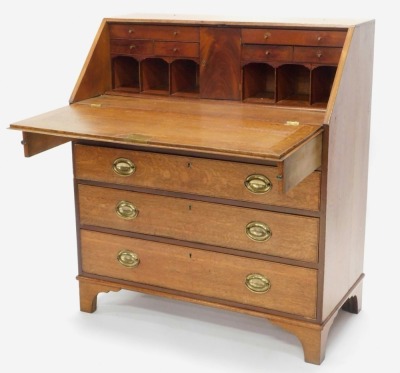 An early 19thC oak and mahogany cross banded bureau, the fall enclosing a fitted interior above four graduated drawers, each with oval brass drop handles, on bracket feet, 106cm high, 93cm wide. - 2