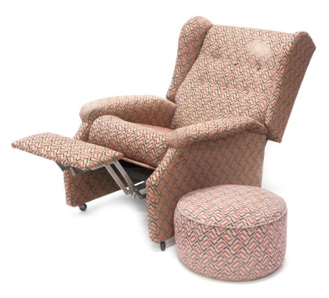 A reclining armchair, with grey and red geometric pattern fabric, and matching footstool. The upholstery in this lot does not comply with the 1988 (Fire & Fire Furnishing) Regulations, unless sold to a known exporter or upholsterer it will be cut from th