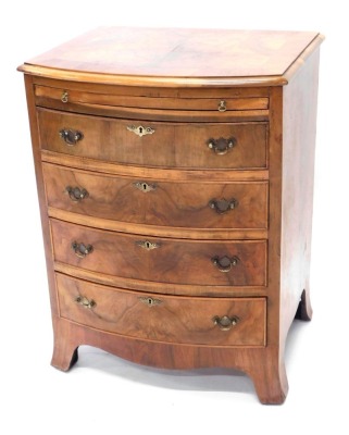 A walnut and figured walnut bow fronted chest, the quarter veneered top with a cross banded border and a moulded edge above a brushing slide, and four drawers, each with brass drop handles, on splayed feet, 77cm high, 58cm wide.