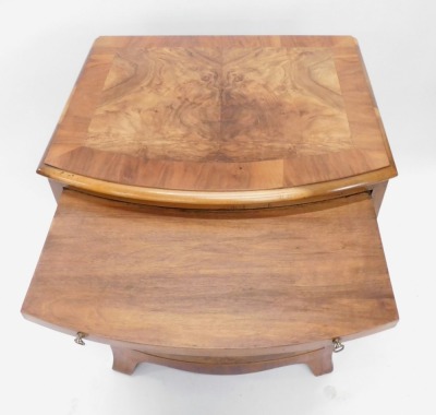 A walnut and figured walnut bow fronted chest, the quarter veneered top with a cross banded border and a moulded edge above a brushing slide, and four drawers, each with brass drop handles, on splayed feet, 77cm high, 58cm wide. - 2