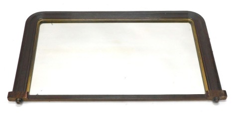 A late Victorian over mantle mirror, painted to simulate timber, with an arched top and gilt slip, on bun feet, 98cm wide.