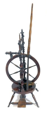 A 19thC fruitwood spinning wheel, with turned supports, and spoked wheel, on oval platform with turned legs, 118cm high.