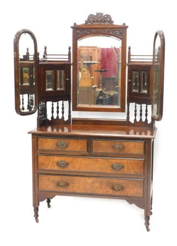 A late 19th/early 20thC walnut and figured walnut dressing chest, the raised back with a central mirror flanked by mirrored glazed supports, and two further mirrors, the base with two short and two long drawers, on turned legs with castors, the base 82cm