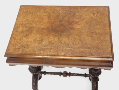 A Victorian walnut and figured walnut work table, the rectangular hinged inlaid top with a moulded edge enclosing a fitted interior, on spirally turned and leaf carved supports, with similar stretcher, on scroll carved splayed legs with ceramic castors, 7 - 2