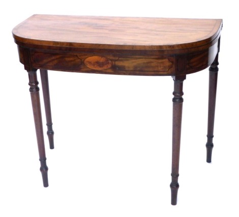 An early 19thC mahogany D shaped card table, the boxwood strung top with a cross banded border, above a plain frieze, on turned tapering legs, 72cm high, 89cm wide.