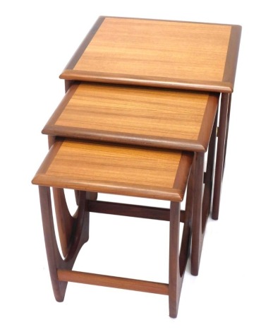 A nest of three G Plan teak tables, each on end supports, the largest 49cm wide.