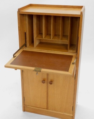 A light oak escritoire or bureau, in Heals style, with a raised gallery, enclosing a fitted interior with brown leatherette insert, with frieze drawer and two doors, each with turned handles, on a plinth, unmarked, 117cm high, 59cm wide. - 2