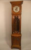 An early 20thC Art Nouveau style longcase clock with a silvered chapter ring and decorative copper c