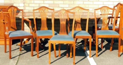 A yew veneered dining table in regency style, the rectangular ebony strung and cross banded top with rounded ends and reeded edges, on turned column and reeded splayed legs, 71cm high, 182cm wide, 92cm deep, and a set of six similar mahogany dining chairs