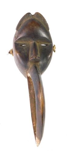 An African tribal Dan Maou Meditation mask, with stylised beak, Cote D'Ivoire circa 1980, 52cm long.