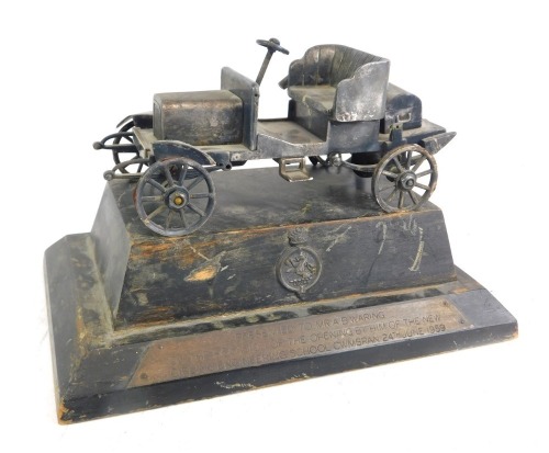 A steel scale model of a 1906 Rover Motor Car, made by the Girling Apprentices 1959, the stepped wooden base being titled and marked verso PRESENTED TO MR. A. B. WARING ON THE OCCASION OF THE OPENING BY HIM OF THE NEW GIRLING ENGINEERING SCHOOL CWBRAN 24t