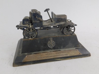 A steel scale model of a 1906 Rover Motor Car, made by the Girling Apprentices 1959, the stepped wooden base being titled and marked verso PRESENTED TO MR. A. B. WARING ON THE OCCASION OF THE OPENING BY HIM OF THE NEW GIRLING ENGINEERING SCHOOL CWBRAN 24t - 2