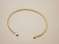 A 9ct gold twisted slave bangle