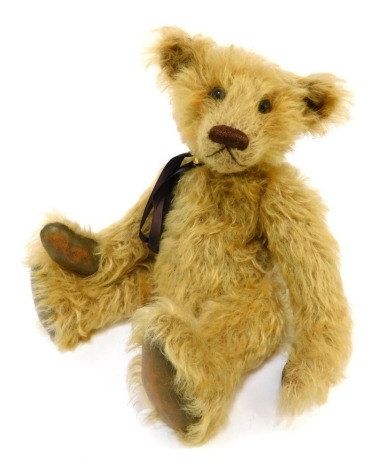 A Winter Bears mohair growler Teddy bear, named Russell, designed and created by Jacqueline Winter, jointed, with ribbon and bell necklace, leather pads, 35cm high overall.