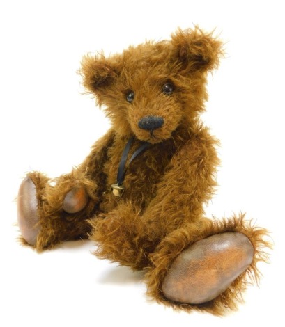 A Winter Bears mohair growler Teddy bear, named Bourneville, designed and created by Jacqueline Winter, brown colouring, bell and ribbon necklace, leather pads, 35cm high overall.