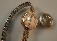 A small 9ct gold locket and a 1930's ladies gold cased wristwatch.