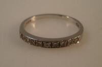 A diamond and platinum ½ hoop eternity ring