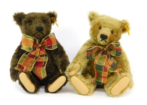 Two Steiff mohair Teddy bears, in brown and caramel colouring, each with a tartan bow necklace, numbered 000829 and 000713, each 23cm high.