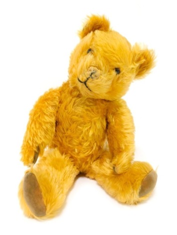 A mid century jointed Teddy bear, in caramel, with velvet pads, 49cm high.