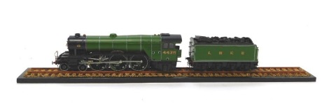 An O gauge Class A3 Flying Scotsman locomotive and tender, 4472, 4-6-0, apple green livery, with a section of track, together with Flying Scotsman locomotive bound magazines. (a quantity)