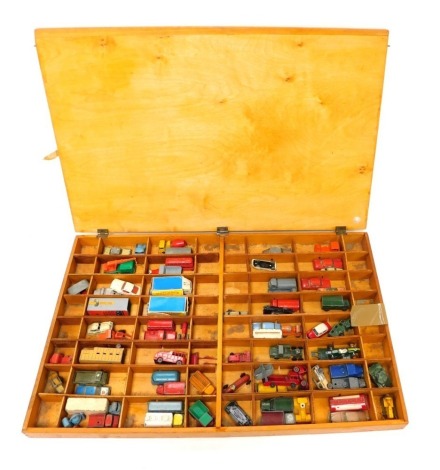 Various diecast cars, play worn, to include Matchbox 1958 Vauxhall Cresta, Ford 3 tonne service ambulance, other Matchbox cars, etc., contained in a sectional wooden case with lid, the case 69.5cm wide.