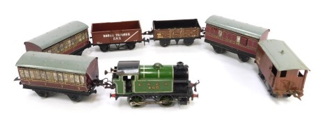 An O gauge tin plate locomotive, LNER 460, green livery, together with four carriages, and two items of rolling stock. (1 tray)