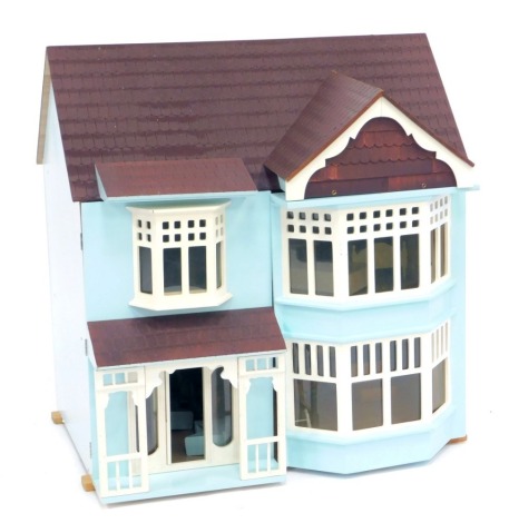 An Exmouth style dolls house, with furniture and accessories.