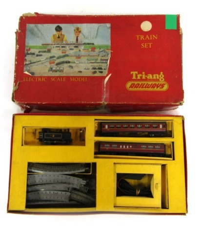 A Tri-ang Railways OO gauge train set, including a 0-6-0 locomotive, BR lined black livery, two Hornby OO coaches, Tri-ang track and transformer.