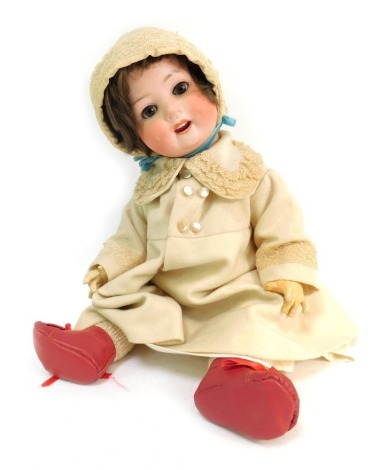 A German porcelain bisque headed doll, with roll eyes, brown hair and teeth, stamped Heubach Koppelsdorf 300.7, in cream dress, 46cm long.