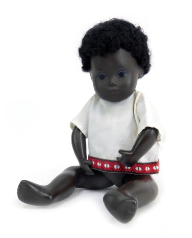 A 1970s Sasha black faced doll, 'The Bold Doll', of a seated child with blue eyes, 7cm high.