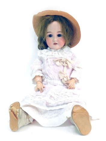 An Armand Marseille bisque headed doll, with roll brown eyes and teeth, blonde hair with articulated limbs, in pink and lace flowing gowns, stamped 392A8M, 55cm long.