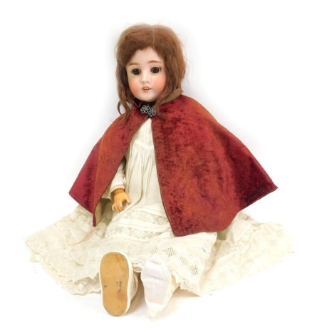 A Simon & Halbeg German bisque headed 20thC doll, with roll brown eyes and teeth, brown hair, stamped SHPB & * 1906, with articulated limbs, with red evening cape, 64cm high.