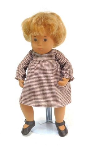 A 1970s Sasha doll, of girl with brown eyes and blonde hair in brown chequered dress with shoes, 29cm high.